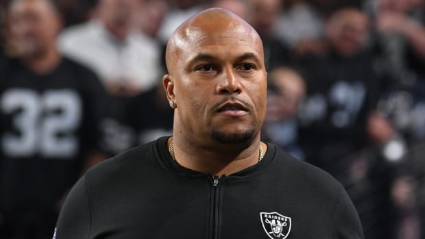 Raiders coach Antonio Pierce walks onto the field before a game.